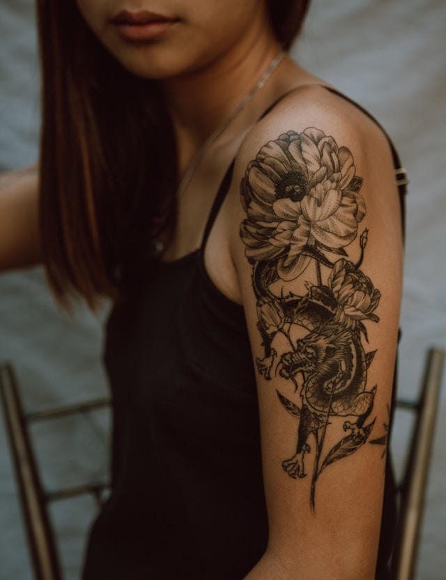 Tattoo artist working on client